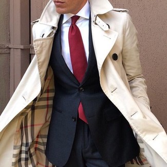 Red Tie Outfits For Men: This polished pairing of a beige trenchcoat and a red tie is a common choice among the fashion-forward chaps.