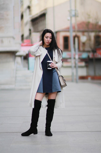 Beige Trenchcoat Outfits For Women: If you're after a laid-back but also absolutely stylish outfit, opt for a beige trenchcoat and a navy skater dress. When not sure about the footwear, slip into black suede over the knee boots.