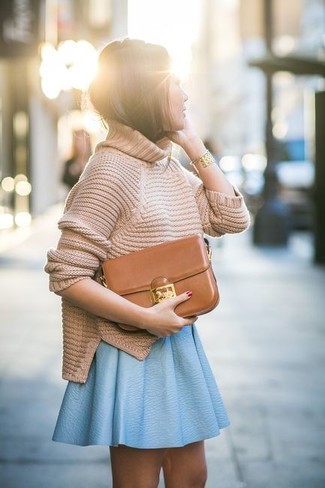 Tan Turtleneck Outfits For Women: This combination of a tan turtleneck and a light blue leather skater skirt combines comfort and efficiency and helps you keep it low profile yet trendy.