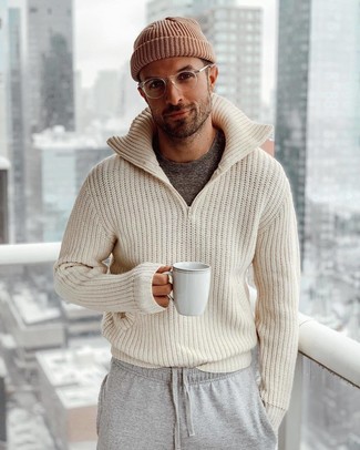 Beige Knit Zip Sweater Outfits For Men: A beige knit zip sweater looks especially nice when married with grey sweatpants in a casual getup.
