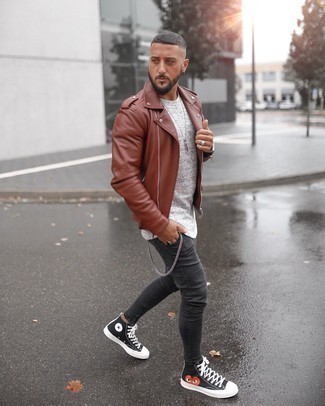Charcoal Skinny Jeans Outfits For Men: Wear a tobacco leather biker jacket and charcoal skinny jeans to feel 100% confident and look sharp. Now all you need is a pair of black print canvas high top sneakers.
