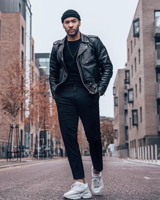 Black Leather Biker Jacket Outfits For Men: This combination of a black leather biker jacket and black chinos is a good menswear style for off duty. Break up this ensemble by sporting beige athletic shoes.