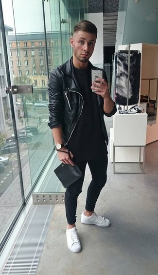 Black Leather Zip Pouch Outfits For Men: You're looking at the undeniable proof that a black leather biker jacket and a black leather zip pouch are amazing when matched together in an urban ensemble. Want to dial it up with footwear? Complete your look with a pair of white leather low top sneakers.