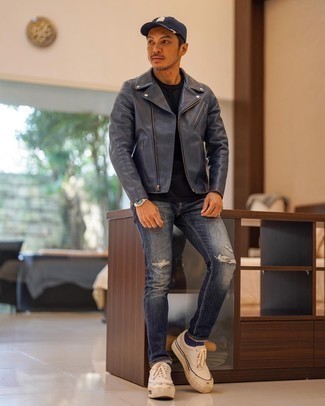 Navy Ripped Jeans Outfits For Men: Pair a charcoal leather biker jacket with navy ripped jeans for both dapper and easy-to-achieve getup. For something more on the smart side to complement your ensemble, complete your outfit with a pair of white canvas low top sneakers.