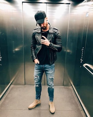 Black Quilted Leather Biker Jacket Outfits For Men: Showcase your prowess in men's fashion by wearing this laid-back combo of a black quilted leather biker jacket and blue ripped skinny jeans. A good pair of beige suede chelsea boots is a simple way to breathe a sense of sophistication into your outfit.