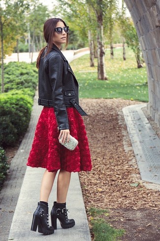 A black leather biker jacket and a red textured full skirt are a go-to combo for many fashion-savvy ladies. Go ahead and add a pair of black leather lace-up ankle boots to the mix for a hint of sophistication.