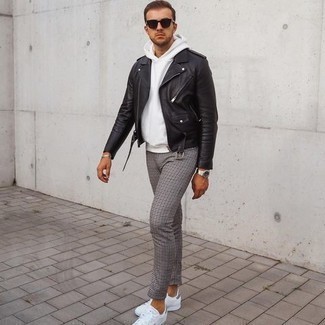 Black Biker Jacket Outfits For Men: A black biker jacket and grey houndstooth chinos are the kind of a tested casual ensemble that you need when you have no extra time to put together a look. On the footwear front, this ensemble pairs nicely with white canvas low top sneakers.