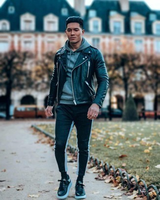 Black and White Leather Low Top Sneakers Outfits For Men: A black leather biker jacket and black and white chinos are a go-to combination for many fashionable gents. A good pair of black and white leather low top sneakers pulls this outfit together.