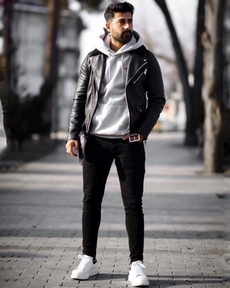 Grey Hoodie Outfits For Men: Such pieces as a grey hoodie and black skinny jeans are an easy way to introduce toned down dapperness into your current collection. Go ahead and introduce white and black leather low top sneakers to this look for a touch of sophistication.