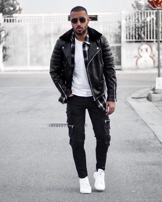 Black Cargo Pants Outfits: Showcase your skills in menswear styling by combining a black leather biker jacket and black cargo pants for a casual getup. White leather low top sneakers are a safe footwear option here that's full of personality.
