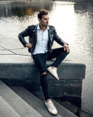 Navy Skinny Jeans Relaxed Outfits For Men: If you're scouting for a bold casual and at the same time seriously stylish ensemble, try pairing a black quilted leather biker jacket with navy skinny jeans. A trendy pair of white and black print canvas low top sneakers is the most effective way to inject an extra dose of refinement into this ensemble.