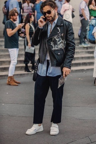 Black Print Leather Biker Jacket Outfits For Men: A black print leather biker jacket and navy chinos are a cool combination to add to your day-to-day styling collection. Let your styling skills truly shine by finishing off your ensemble with white leather low top sneakers.