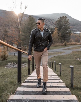 If the situation permits casual styling, you can wear a black leather biker jacket and khaki jeans. Complete this outfit with a pair of black leather casual boots to kick things up to the next level.