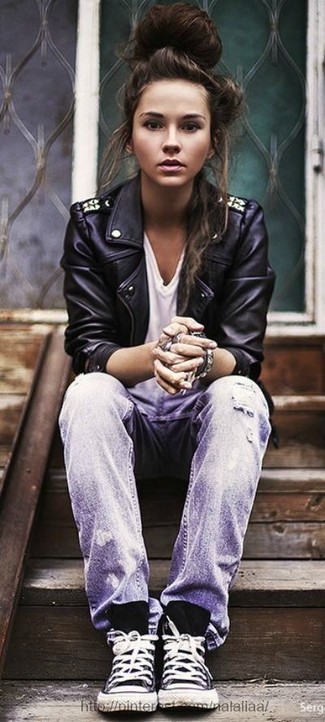 Grey Ripped Jeans Outfits For Women: For a goofproof relaxed casual option, you can never go wrong with this combo of a black studded leather biker jacket and grey ripped jeans. Look at how great this ensemble is finished off with a pair of black and white high top sneakers.