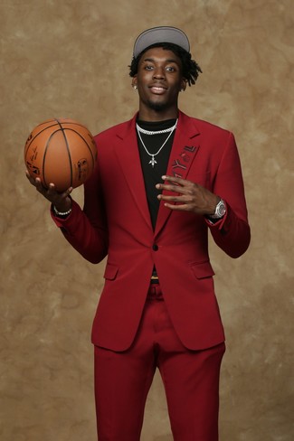 Nassir Little wearing Silver Watch, Black and White Baseball Cap, Black Crew-neck T-shirt, Red Suit