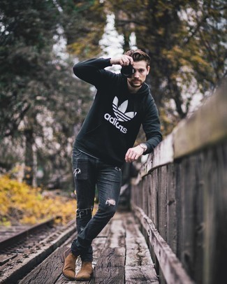 Black and White Print Hoodie Outfits For Men: Make a black and white print hoodie and charcoal ripped jeans your outfit choice to achieve new heights in your personal style. Avoid looking too casual by rounding off with a pair of brown suede chelsea boots.