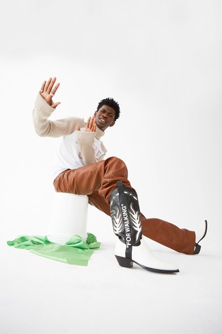 Lil Nas X wearing Black and White Leather Cowboy Boots, Tobacco Leather Chinos, Beige Knit Turtleneck