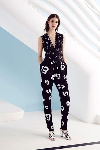 Make a black and white leopard jumpsuit your outfit choice for an ensemble that's both laid-back and chic. Bring a sense of sultry class to this look by slipping into a pair of white and black leather heeled sandals.
