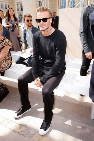 David Beckham wearing Black and White Low Top Sneakers, Black Chinos, Black Crew-neck Sweater