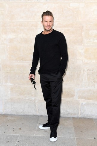 David Beckham wearing Black and White Low Top Sneakers, Black Chinos, Black Crew-neck Sweater