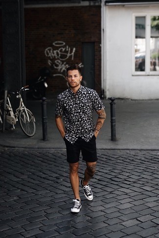 Black Short Sleeve Shirt Outfits For Men: Wear a black short sleeve shirt and black shorts for a dapper, casual look. Let your sartorial chops truly shine by rounding off this look with a pair of black and white canvas low top sneakers.