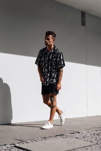 Black Print Short Sleeve Shirt Outfits For Men: Master the cool and casual look by wearing a black print short sleeve shirt and black denim shorts. Let your styling chops truly shine by rounding off your look with a pair of white canvas low top sneakers.