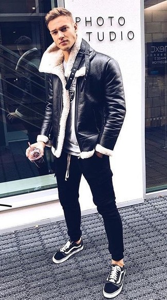 Black Shearling Jacket Outfits For Men: This combination of a black shearling jacket and black sweatpants will hallmark your skills in menswear styling even on dress-down days. Black and white canvas low top sneakers are a good pick to finish your outfit.