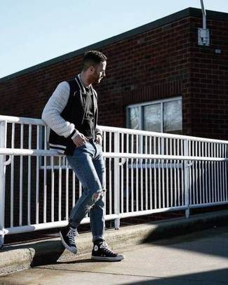Black Varsity Jacket Outfits For Men: Consider teaming a black varsity jacket with blue ripped jeans for a modern twist on day-to-day style. This look is completed really well with a pair of black and white canvas high top sneakers.