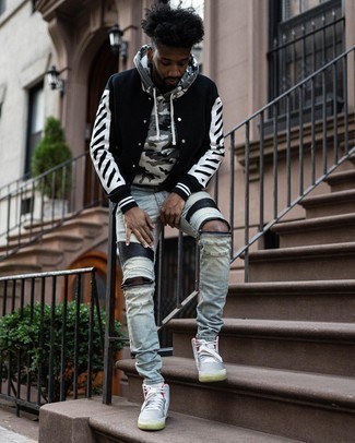 Black and White Varsity Jacket Outfits For Men: A black and white varsity jacket and light blue ripped jeans are the perfect foundation for a cool and casual look. Grey canvas high top sneakers look wonderful complementing your look.