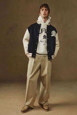 Varsity Jacket Outfits For Men: Wear a varsity jacket and khaki chinos for a comfortable look that's also pieced together nicely. And if you want to easily step up this ensemble with one single piece, why not add a pair of tan leather loafers to the equation?