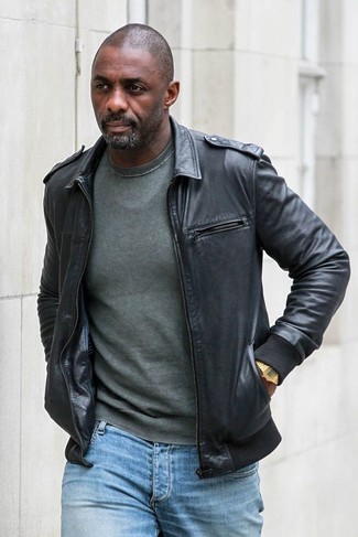 Idris Elba wearing Black Leather Bomber Jacket, Dark Green Crew-neck Sweater, Light Blue Jeans, Gold Watch