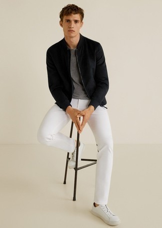 Black Bomber Jacket Outfits For Men: This combination of a black bomber jacket and white chinos is proof that a safe casual ensemble can still be really interesting. Puzzled as to how to finish? Introduce white leather low top sneakers to the mix to shake things up.