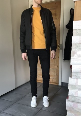 Yellow Sweatshirt Outfits For Men: This laid-back pairing of a yellow sweatshirt and black jeans is very easy to pull together without a second thought, helping you look on-trend and ready for anything without spending a ton of time rummaging through your wardrobe. White leather low top sneakers are the glue that ties this outfit together.