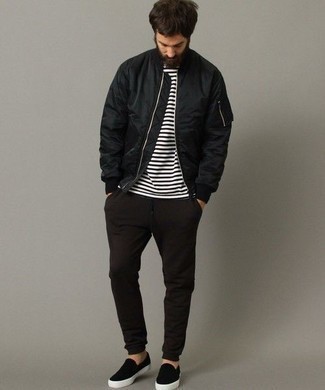 Dark Brown Chinos Outfits: If you don't like getting too predictable with your getups, go for a black bomber jacket and dark brown chinos. Black canvas slip-on sneakers integrate seamlessly within a multitude of getups.