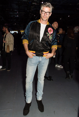 Black Embroidered Satin Bomber Jacket Outfits For Men: This casual combo of a black embroidered satin bomber jacket and light blue ripped jeans can go in different directions according to the way it's styled. To bring some extra flair to your look, complement this outfit with black suede chelsea boots.