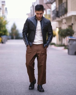 Black Leather Bomber Jacket Outfits For Men: When the setting permits a laid-back outfit, pair a black leather bomber jacket with brown chinos. Puzzled as to how to complement your getup? Wear black leather chelsea boots to amp it up.