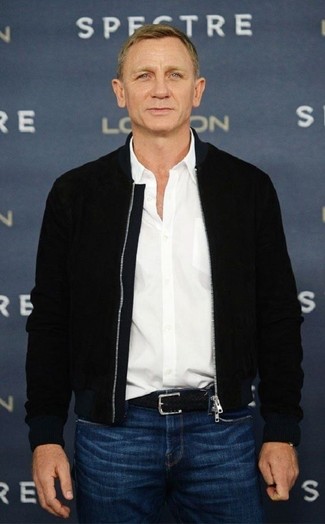 Daniel Craig wearing Black Bomber Jacket, White Long Sleeve Shirt, Blue Jeans, Black Woven Leather Belt