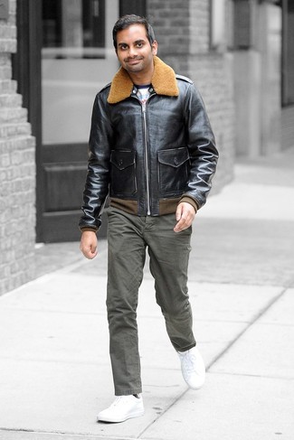 A black leather bomber jacket and olive chinos teamed together are a savvy match. Get a little creative when it comes to footwear and add white leather low top sneakers to this ensemble.
