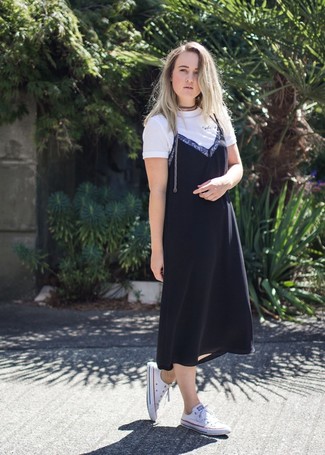 Cami Dress Outfits: Pairing a cami dress with a white crew-neck t-shirt is an amazing idea for a casual but totaly chic outfit. White canvas low top sneakers will effortlessly dress down a polished look.