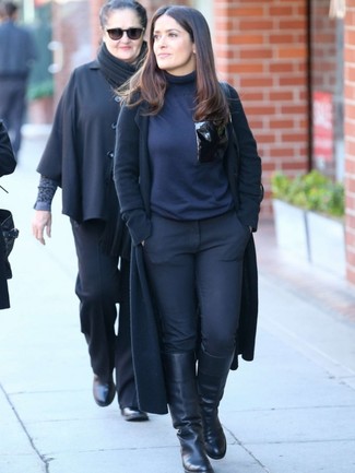 Salma Hayek wearing Black Coat, Navy Turtleneck, Black Skinny Pants, Black Leather Knee High Boots