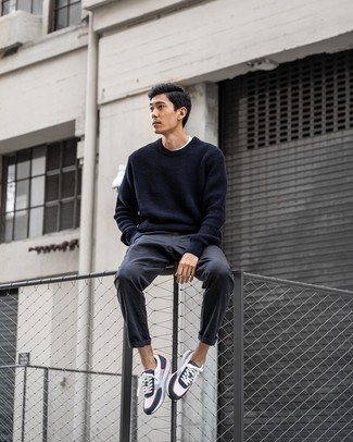 White and Navy Athletic Shoes Outfits For Men: Such must-haves as a black crew-neck sweater and charcoal chinos are the ideal way to inject effortless cool into your casual styling rotation. When this getup is too much, tone it down by finishing off with white and navy athletic shoes.