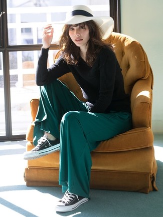 Dark Green Wide Leg Pants Outfits: This pairing of a black crew-neck sweater and dark green wide leg pants is incredibly stylish and yet it's easy and apt for anything. Black and white canvas low top sneakers will bring a more casual finish to an otherwise traditional getup.