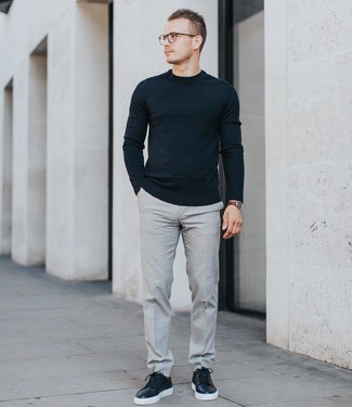Black Leather Low Top Sneakers Outfits For Men: A black crew-neck sweater and grey dress pants are among the unshakeable foundations of a versatile closet. To bring a more laid-back aesthetic to this ensemble, add black leather low top sneakers to this look.