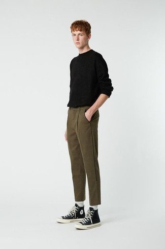 Black Crew-neck Sweater Outfits For Men: Dress in a black crew-neck sweater and olive check chinos for a relaxed menswear style with a contemporary spin. You know how to add a more casual finish to this ensemble: black and white canvas high top sneakers.