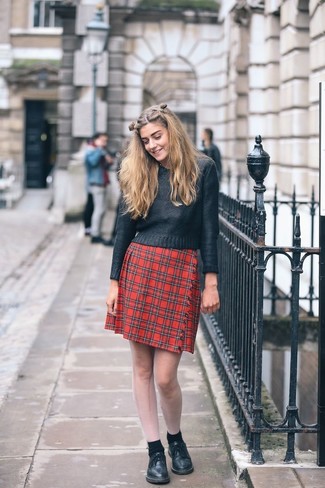 Black Leather Lace-up Flat Boots Outfits For Women: A perfectly pulled together combo of a black crew-neck sweater and a red plaid mini skirt will set you apart effortlessly. Introduce a pair of black leather lace-up flat boots to the mix for maximum effect.