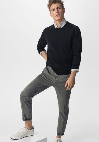 Black Crew-neck Sweater Outfits For Men: The pairing of a black crew-neck sweater and grey chinos makes for a neat relaxed casual ensemble. Want to tone it down in the footwear department? Add white and black leather low top sneakers to the mix for the day.