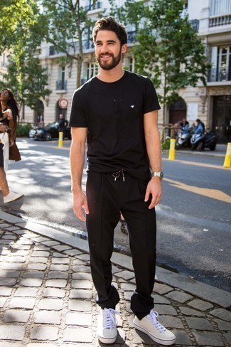 Tan Low Top Sneakers Outfits For Men: If you're searching for a relaxed but also stylish look, choose a black crew-neck t-shirt and black chinos. Our favorite of a great number of ways to complement this outfit is with a pair of tan low top sneakers.