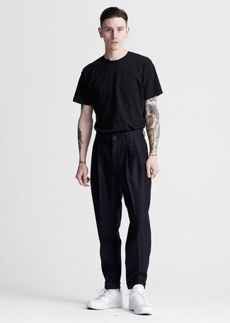 Chinos Outfits: Choose a black crew-neck t-shirt and chinos to achieve a truly dapper and current laid-back outfit. Throw white leather low top sneakers in the mix for maximum style.