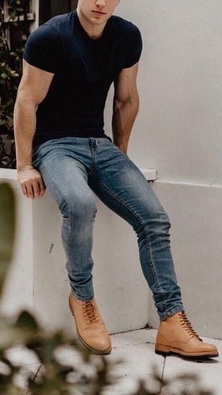 Navy Skinny Jeans Casual Outfits For Men: Parade your skills in men's fashion in this edgy combination of a black crew-neck t-shirt and navy skinny jeans. Why not complete your outfit with tan leather casual boots for an extra dose of style?