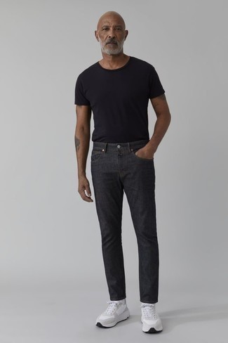 1200+ Hot Weather Outfits For Men: Team a black crew-neck t-shirt with charcoal jeans for both sharp and easy-to-achieve ensemble. For something more on the daring side to round off your outfit, introduce a pair of white athletic shoes to your look.